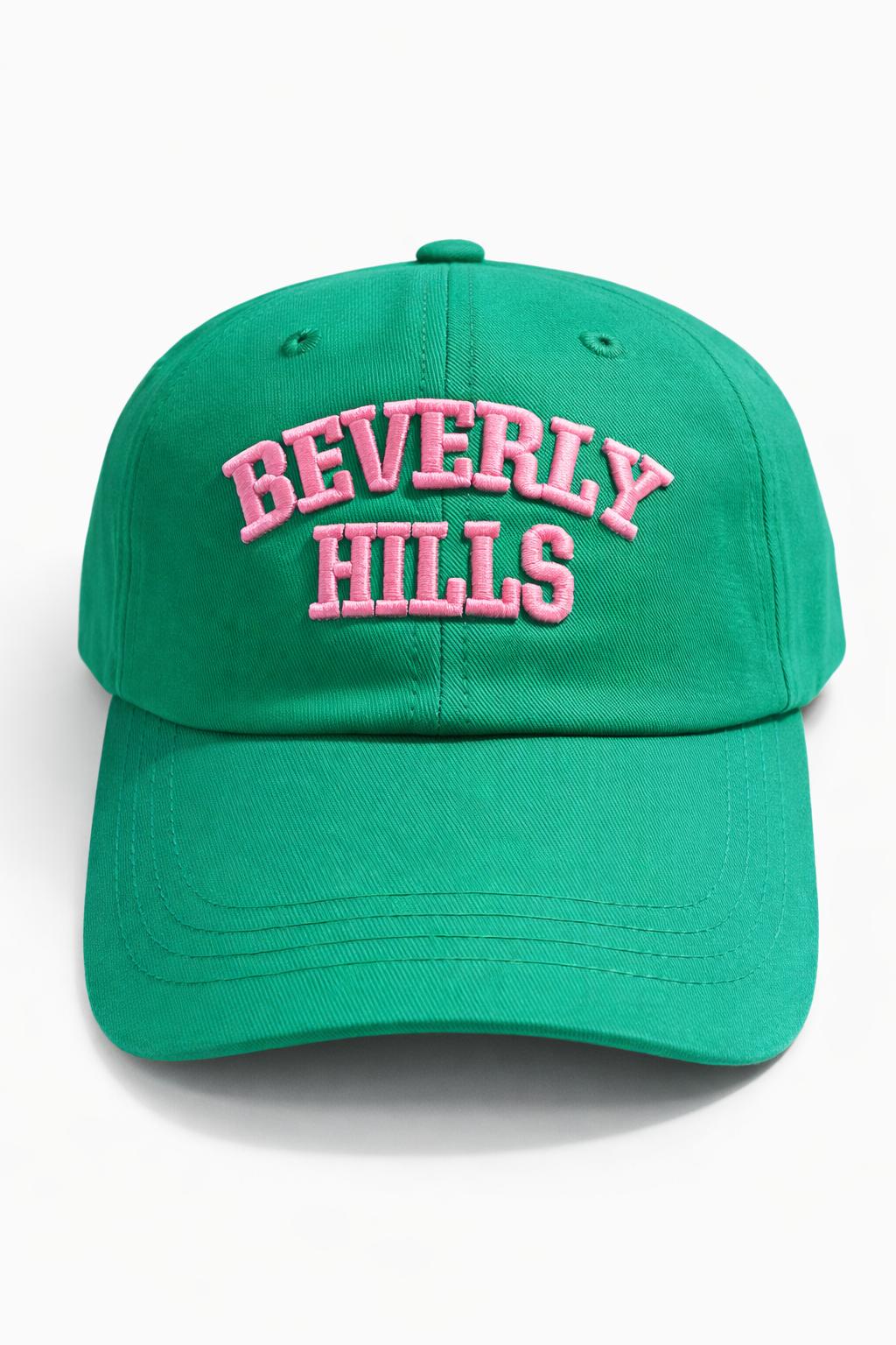 Green cap with 'Beverly Hills' text in pink on a white background