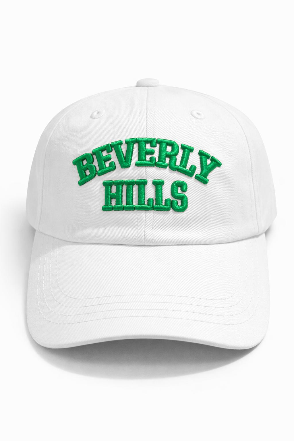White cap with 'Beverly Hills' in green text on a white background