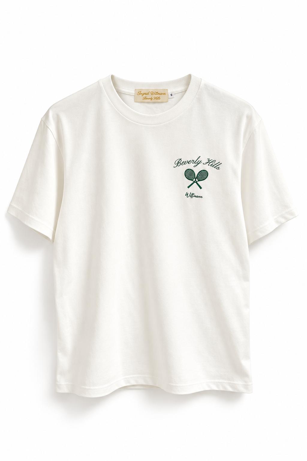An off-white short-sleeve crewneck t-shirt with a green graphic on the left chest featuring the text 'Beverly Hills' and 'Wittmann' above a crossed tennis racket design.